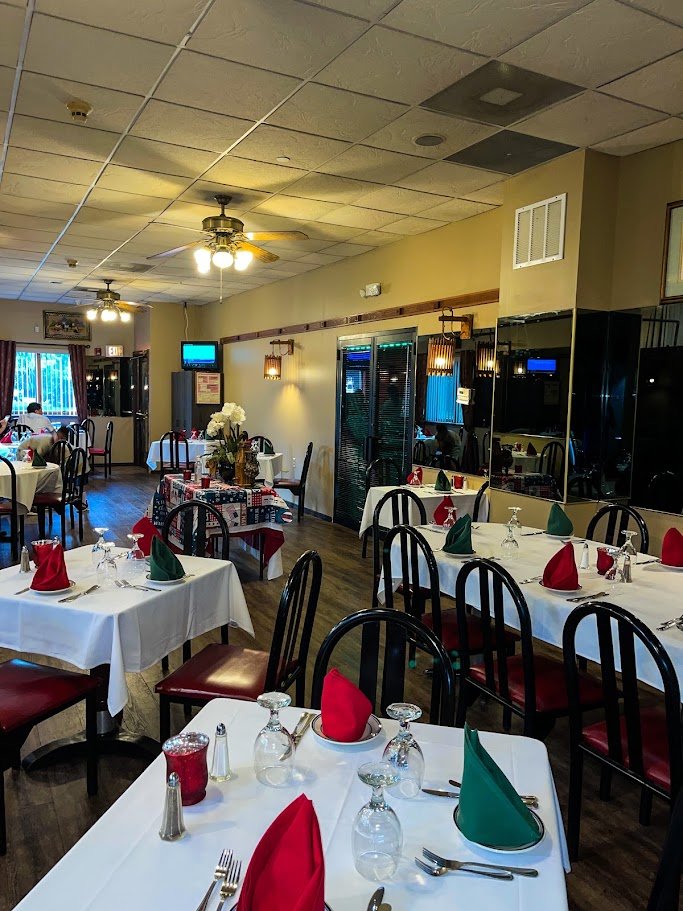 Portuguese restaurant dining room with warm table settings.